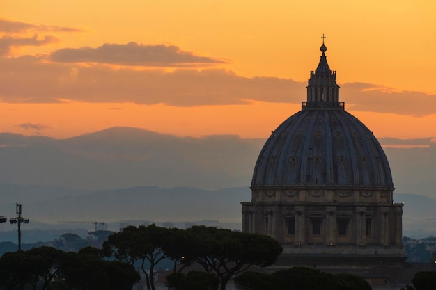 St Peter's basilica dome at sunrise in Rome Italy