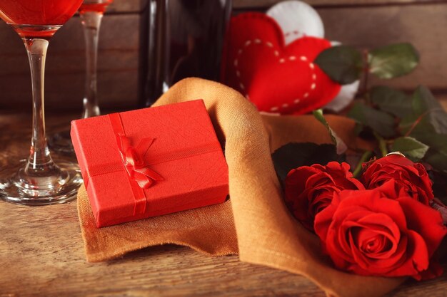 St Valentines Day concept Gift box and beautiful roses on wooden table closeup