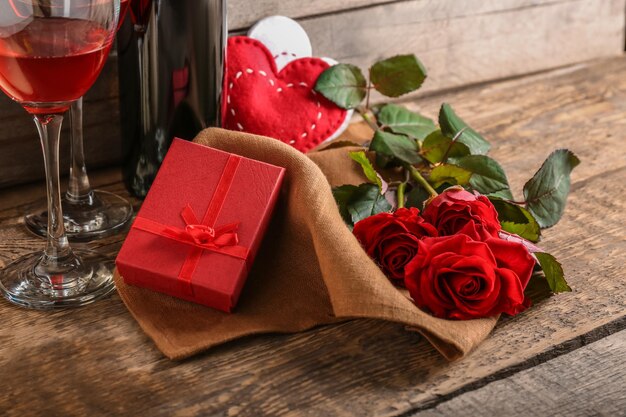 St Valentines Day concept Wine roses and gift box on wooden table