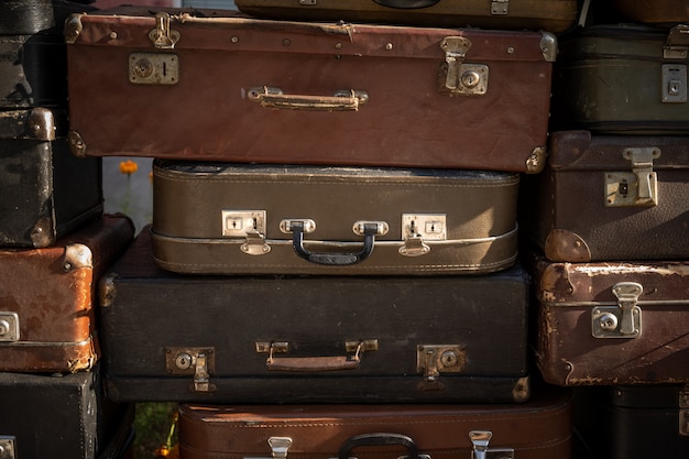 Stack of aged suitcases stacked in a heap.