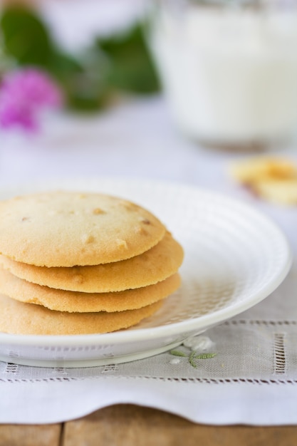 Stack of Almond cookies by a glass of milk