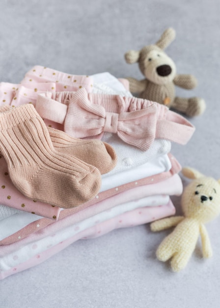 Stack of Baby bodysuits on a grey background