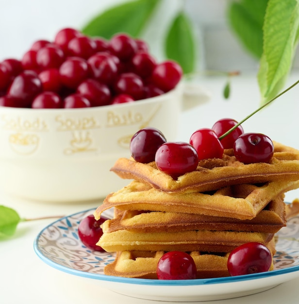 Stack of baked Belgian waffles with ripe red cherries breakfastx9