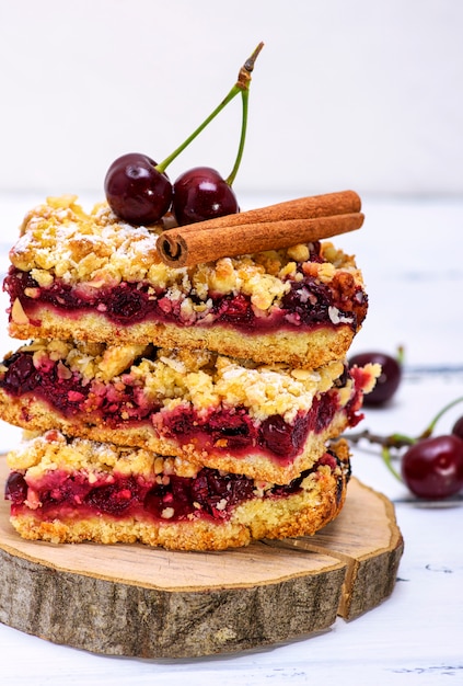 Stack of baked slices of a pie with cherry berries 