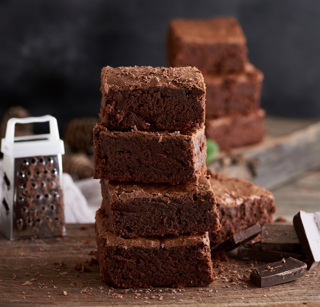 Stack of baked square pieces of chocolate brownie cake