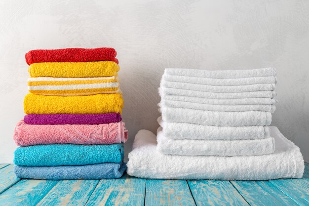 Stack of bath towels on wooden table 