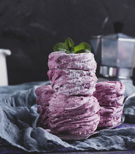 Stack of big pink marshmallows on a gray napkin