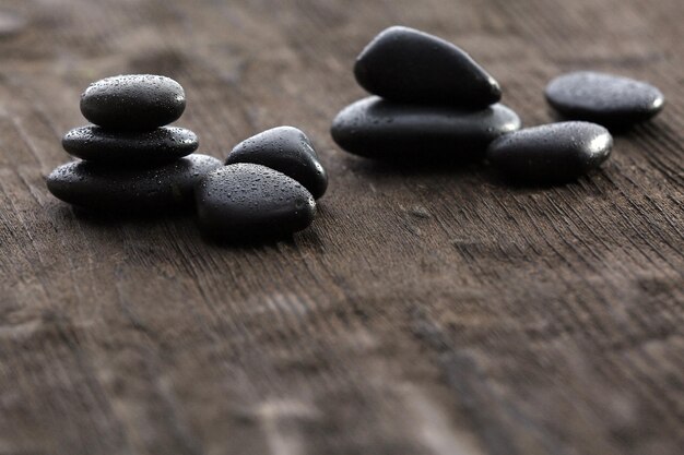 Stack of black sea paddles on rustic wooden background