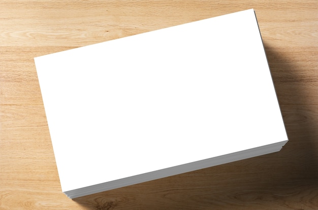 Stack of blank name cards on wooden background