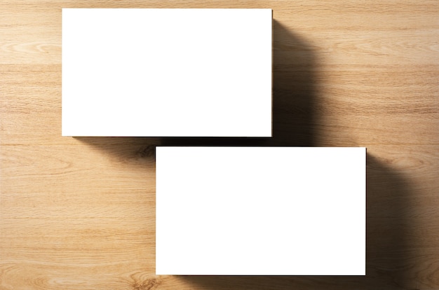 Photo stack of blank name cards on wooden background