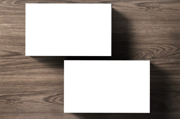 Stack of blank name cards on wooden background