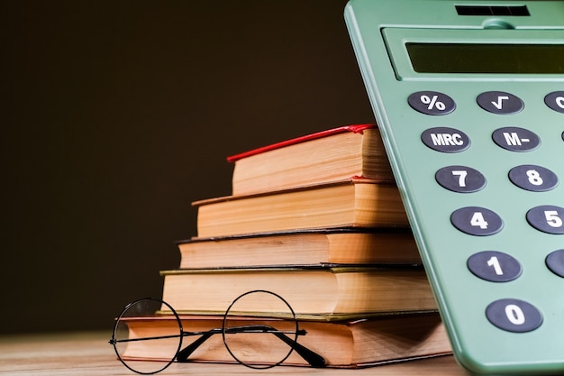 Photo stack of books on dark background free space design