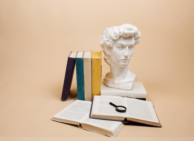 A stack of books with a magnifying glass highlighted on a beige background Search for information