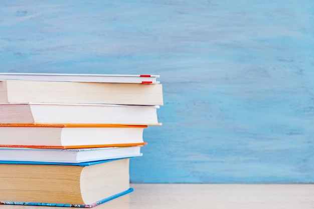 Stack of books on a wooden table