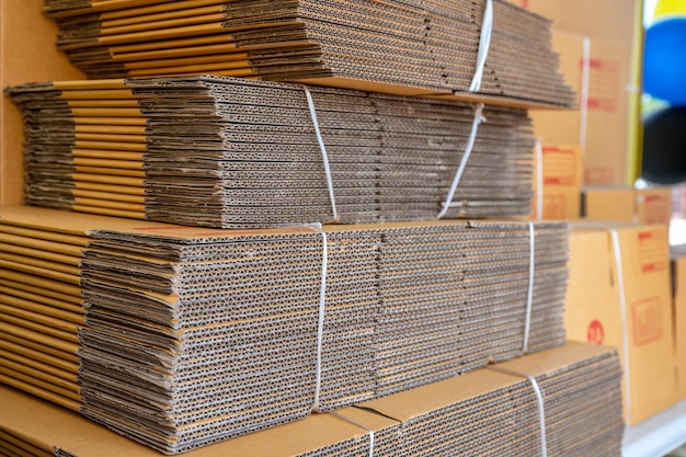 Stack of brown folded cardboard boxes tied