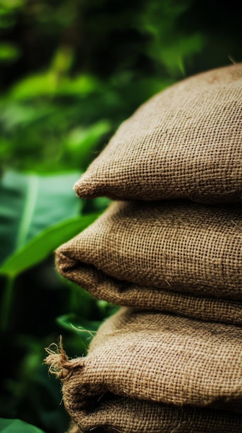 stack of burlap sacks against lush green foliage