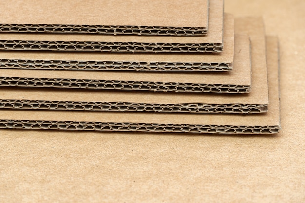 Stack of cardboard for packaging with cells close up as background