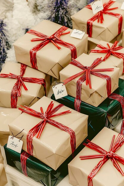 Stack of Christmas Presents Wrapped in Brown Paper and Red Ribbon