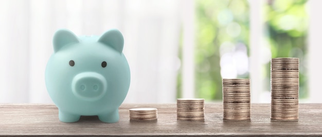 Stack of a coin with trading graph, financial investment concept. and Piggy bank