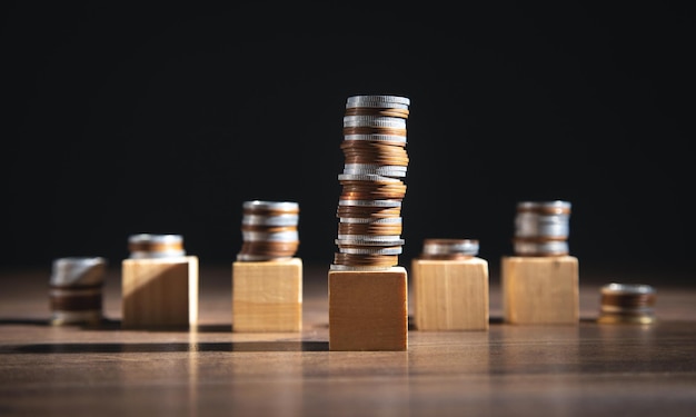 Stack of coins and empty wooden cubes on the table Business Finance