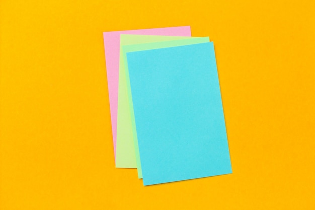 Stack of colored stickers on a vivid yellow background