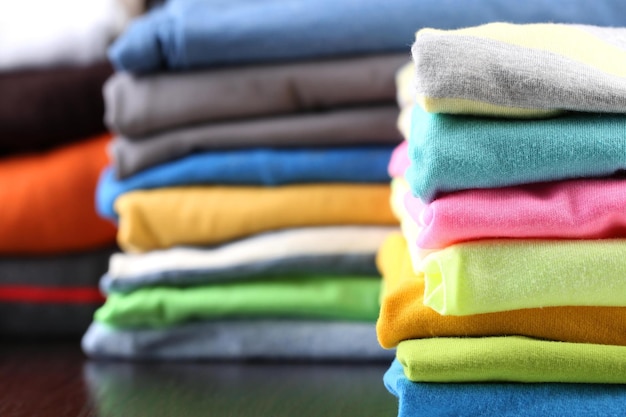 Stack of colorful clothes on dark background