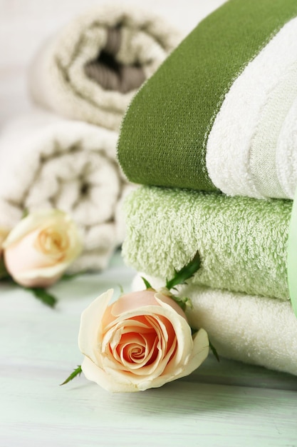 Stack of colorful towels on light wooden background