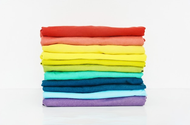 Stack of colorful tshirt on white background