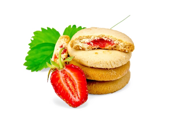 Stack of cookies filled with jam, berries and green leaves of strawberries isolated on white background