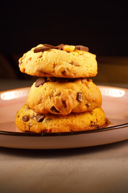 A stack of cookies with chocolate chips on top