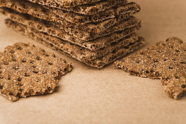 Stack of crispy wheat rye and corn flatbread crackers Healthy food background High angle view