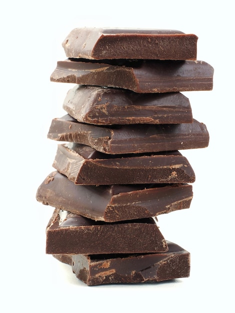 A stack of dark chocolate pieces on a white background