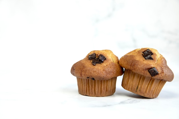 A stack of delicious chocolatechip banana muffins and blueberries on a white background tasty health