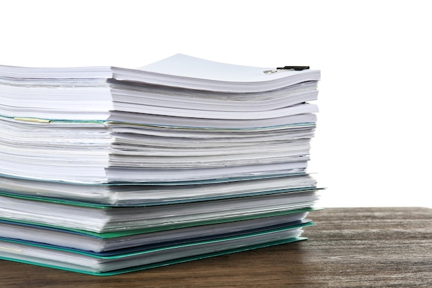 Stack of documents on table against white background