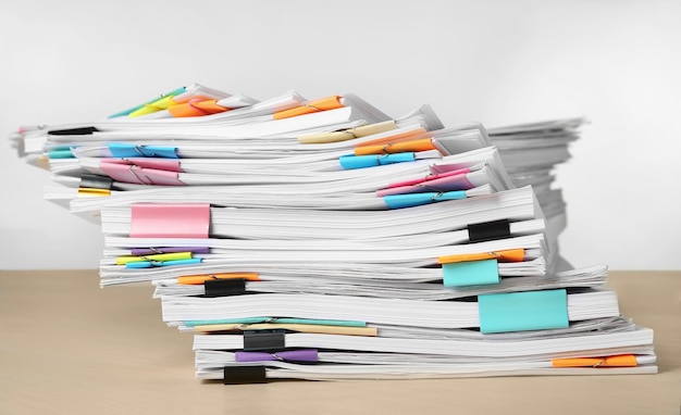 Stack of documents on table against white background