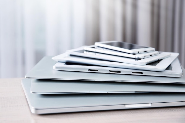 Stack of electronic device on wooden table