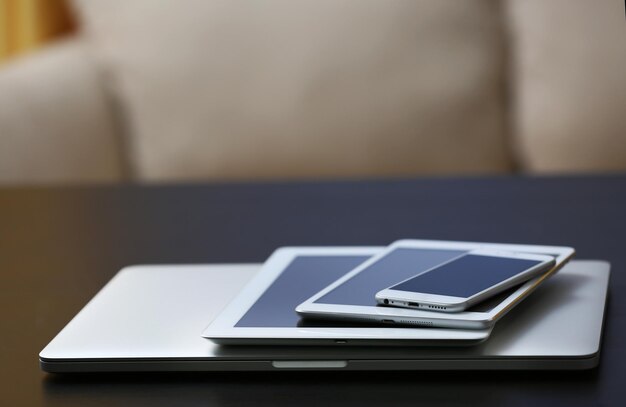 Stack of electronic devices on a dark desk