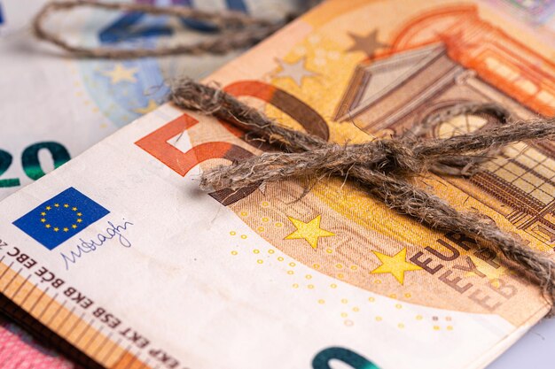 Stack of euro banknotes tied with burlap string closeup wealth and prosperity concept