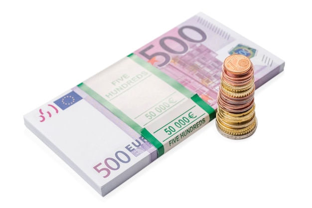 stack of euro cents near a bundle of money with a face value of five hundred euro, isolated on white background