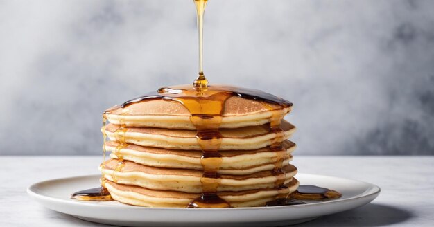 Photo a stack of fluffy pancakes drizzled with maple syrup