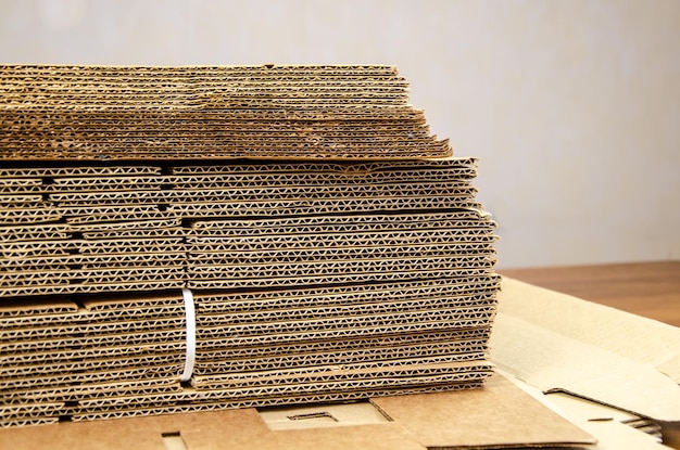 Stack of folded sheets of corrugated cardboard. Recycled materials, sustainable packaging. No waste. corrugated board for packing, bale of paper box.