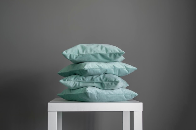 A stack of four grey pillows home cozy decor