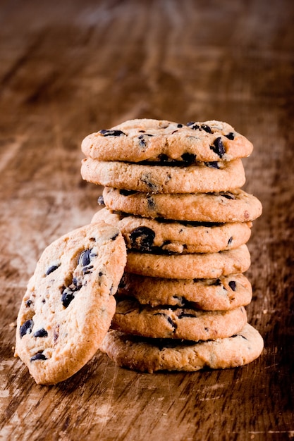 Stack of fresh baked cookies closeup on wooden background