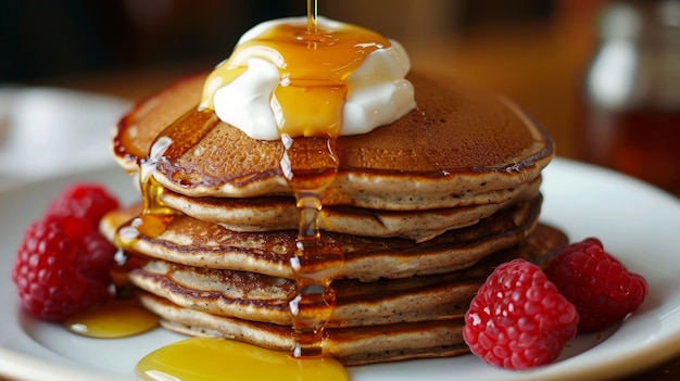 A stack of freshly cooked buckwheat pancakes topped with a dollop of creamy greek yogurt and