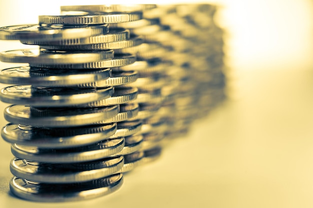 Stack of golden coins macro. Rows of coins for finance and banking concept. Economy trends background for business idea and all art work design. Closeup, Shallow depth of field. Toned.