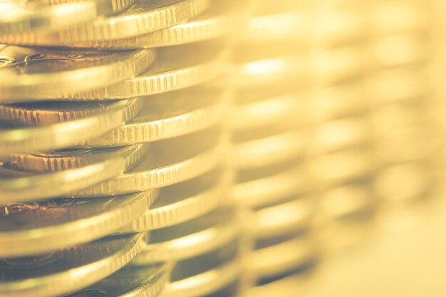 Photo stack of golden coins macro. rows of coins for finance and banking concept. economy trends background for business idea and all art work design. closeup, shallow depth of field. toned.