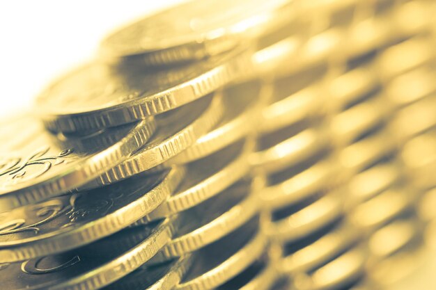 Stack of golden coins macro. Rows of coins for finance and banking concept. Economy trends background for business idea and all art work design. Closeup, Shallow depth of field. Toned.