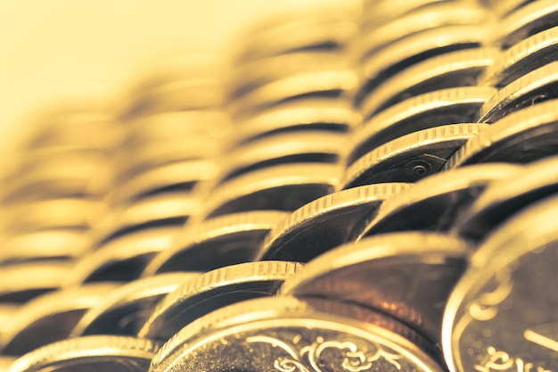 Photo stack of golden coins macro. rows of coins for finance and banking concept. economy trends background for business idea and all art work design. closeup, shallow depth of field. toned.