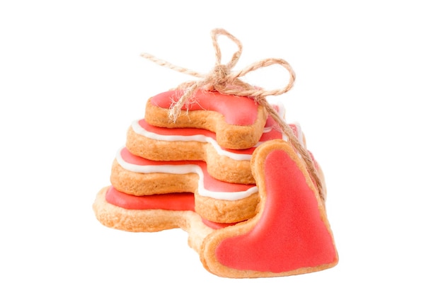 Stack of handmade heart cookies tied with twine isolated on white background. Sweet present for valentine day