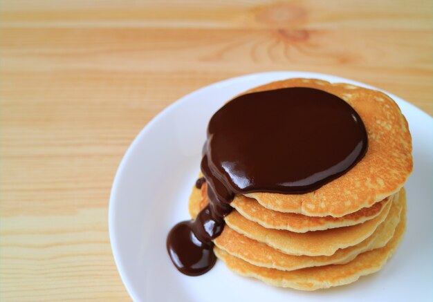 Stack of homemade pancakes with dark chocolate